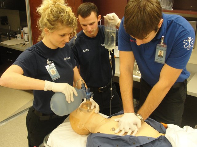 EMS Students administering CPR on SIM man