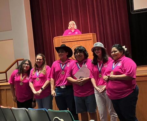 fuentes with leadership group in front of stage