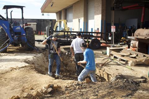 students digging hole