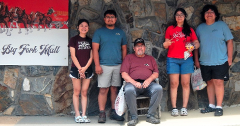 students and McAllister in front of a mall