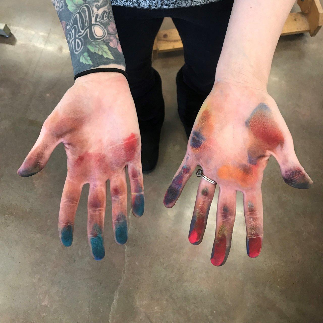 Student with colorful hands