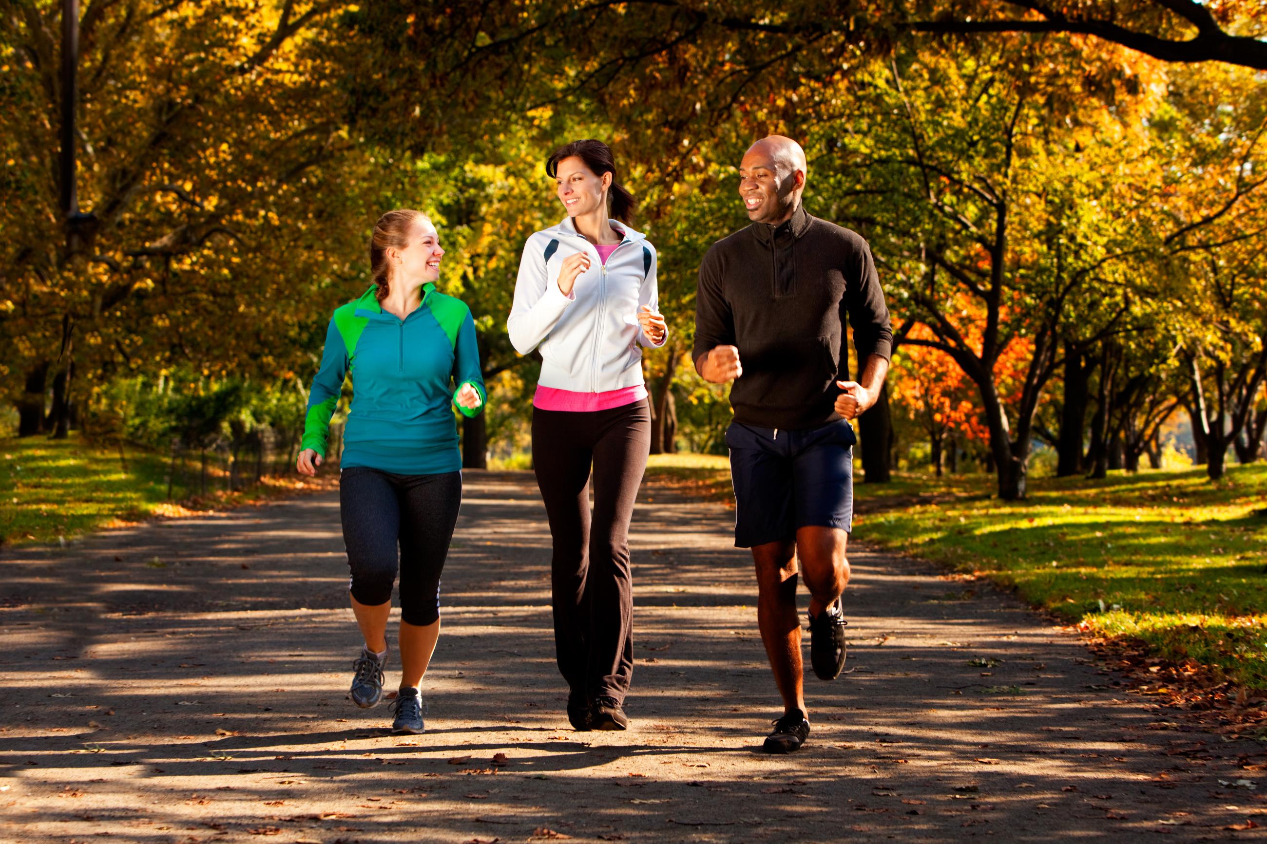 3 people jogging in a park.