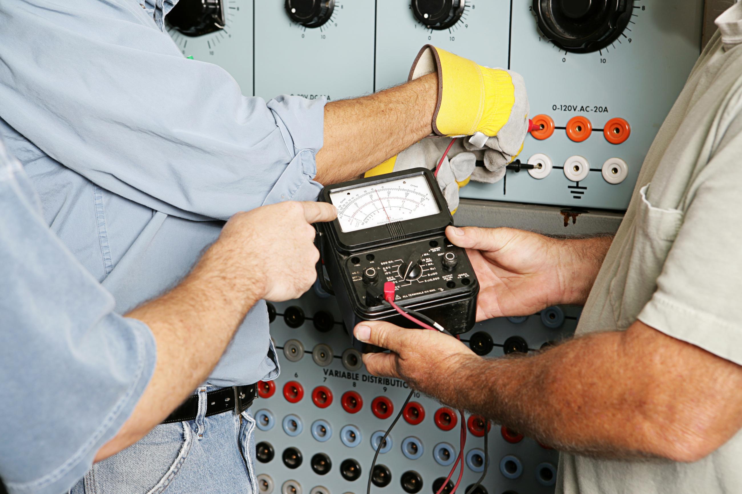 Electricians using ohm meter