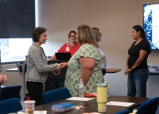 Otero greeting woman at Region 8 event