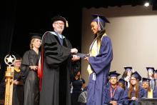 student receiving diploma