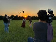 filming in field at sunrise