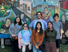 group in front of mural