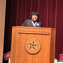 Fuentes speaking on stage