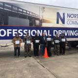 driver graduates in front of truck