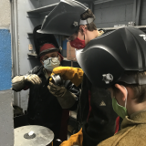 sanchez teaching boys scouts to weld