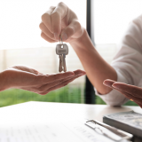 real estate agent handing keys to new homeowner
