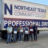 CDL grads in front of truck