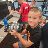 kid showing off robot