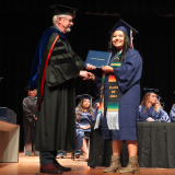 graduate receiving diploma